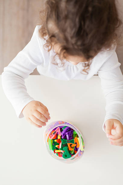istock preschool girl playing with letters 625328584