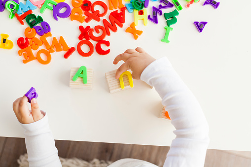 cute little girl playing with letters