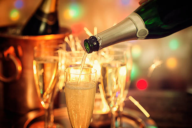 istock Pouring Champagne into Champagne Flutes 625331986