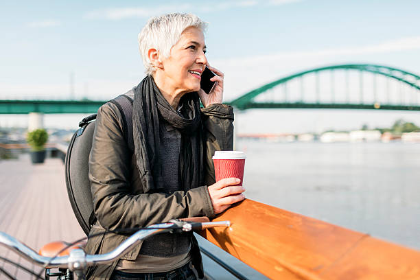 istock Mature Woman Talking On The Phone And Drinking Coffee. 625332484