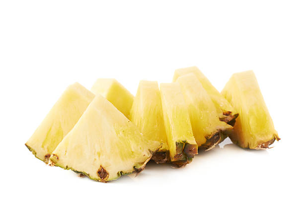 istock Pile of pineapple slices isolated over white background 625333486