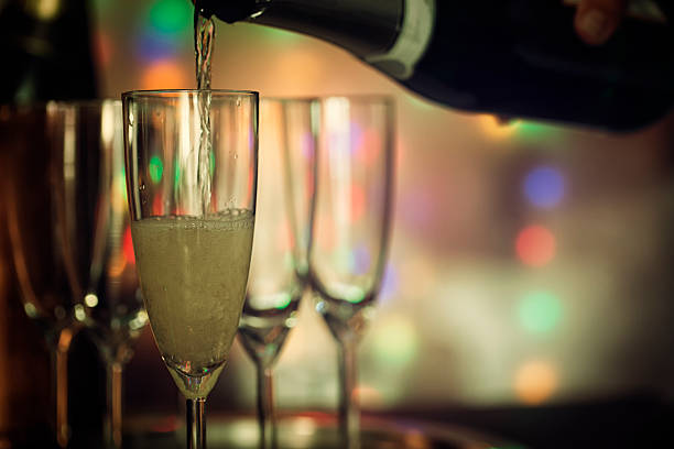 istock Pouring Champagne into Champagne Flutes 625355818
