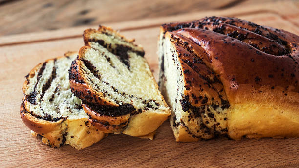 istock poppy seed Roll on a wooden surface, closeup 625355962
