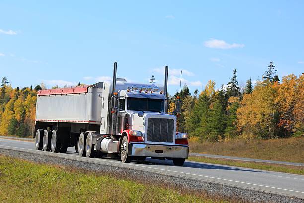 istock Semi truck trailer on an interstate highway, trees in background. 625357684