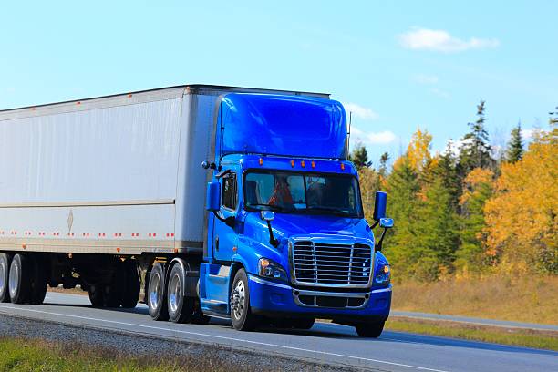 istock Semi truck trailer on an interstate highway, trees in background. 625357768