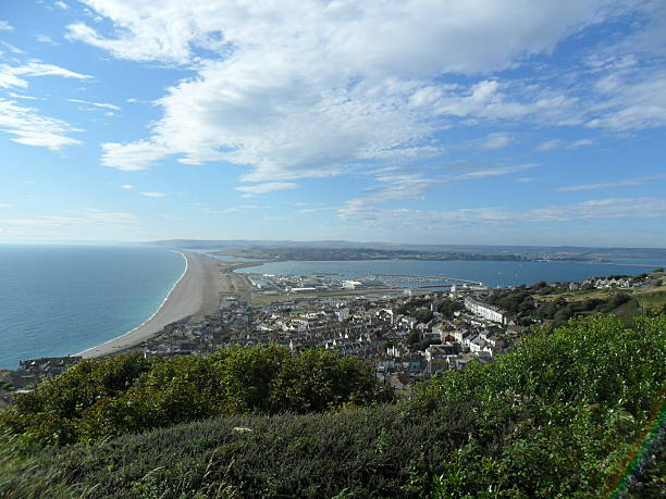 View from Portland Isle, Dorset View from The Heights on Portland Isle, with Portland in the foreground, looking toward Weymouth Bay and Chesil Beach. Image taken 3rd August 2011 at 5.05 pm. bill of portland stock pictures, royalty-free photos & images
