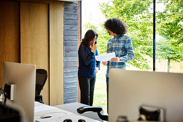 istock Corporate professionals discussing on reports in office 625376104