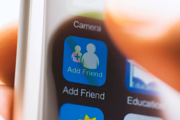 istock Hand touching add friend app icon on screen 625377232