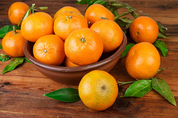 istock Tangerines in brown ceramic bowl closeup 625377824