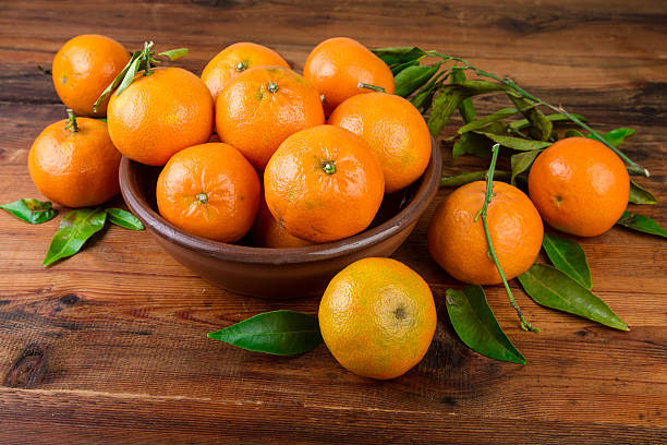 istock Mandarins tangerines in brown ceramic bowl 625378366