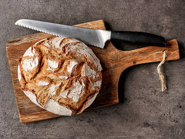 istock freshly baked bread and knife 625380580