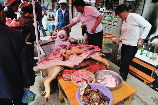 Shaxi, Yunnan, China - April 1, 2011: Local people come to business and shopping from surrounding villages to open-air market, which is held once a week in Shaxi.