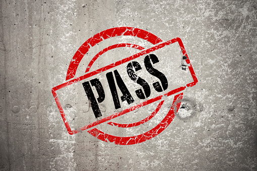 PASS red round stamp on grey and grunge concrete wall background,