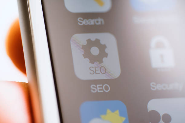 istock Hand holding phone, SEO app on screen 625381574