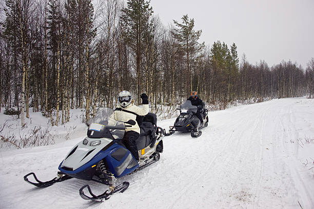 istock People managing a snowmobile in Ruka in Lapland 625382786