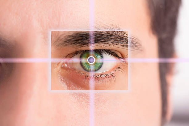 Handsome man pointing to eye stock photo