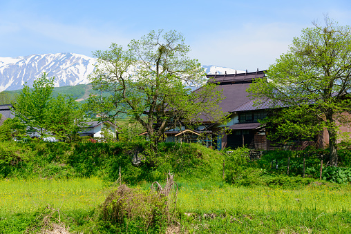 Shirouma mountains and old houses at Ooide park in Nagano