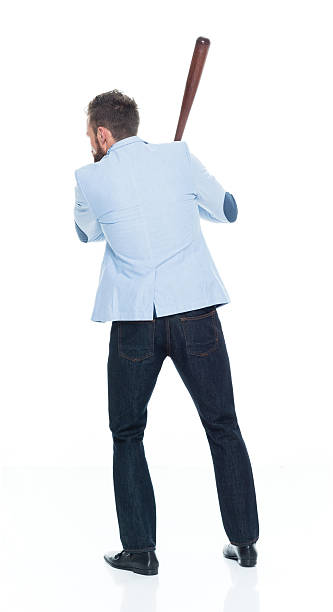 istock Smart casual man in action with baseball bat 625387224