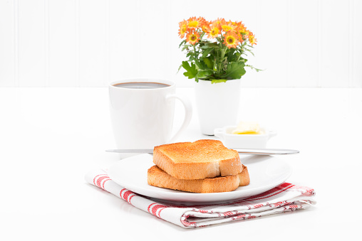 Two pieces of white toast served with fresh brewed coffee.