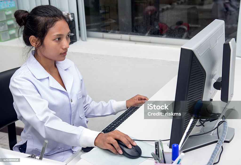 woman doctor working on computer woman doctor working on computer at office Using Computer Stock Photo