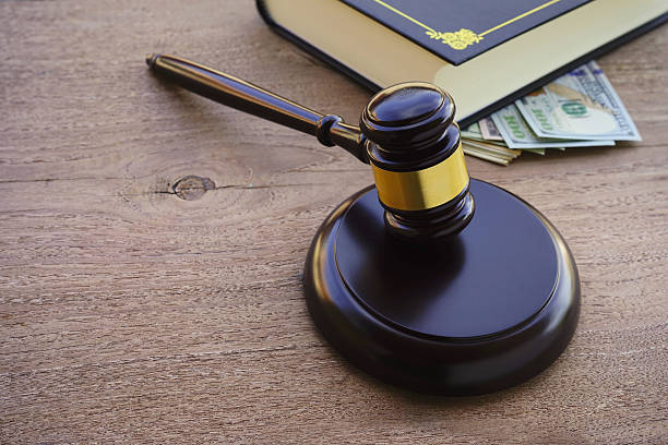 istock Hammers's judiciary with dollars on wooden background. 625394514