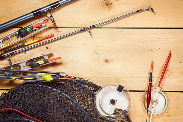 istock Fishing tackles on wooden background 625409678