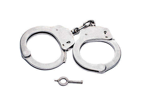 istock handcuffs isolated in white blackground 625412350