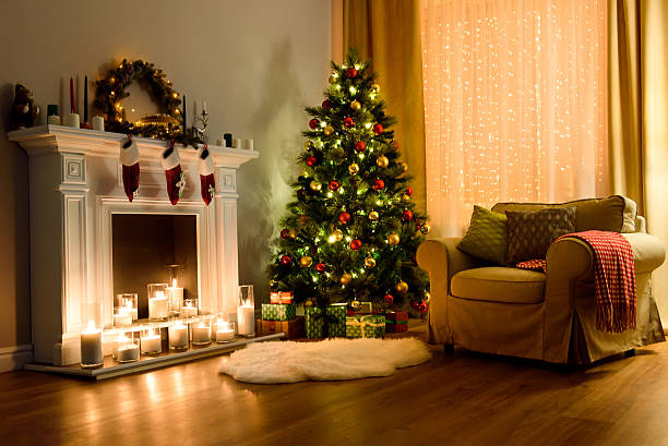 Christmas room interior design A cozy living room lighted with numerous lights decorated ready to celebrate Christmas. Christmas room interior design, Xmas tree decorated by lights, candles and garland lighting indoors fireplace. candlelight photos stock pictures, royalty-free photos & images