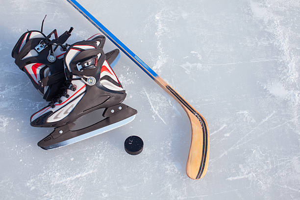 istock Hockey Stick and Puck on the Ice Rink. 625416372