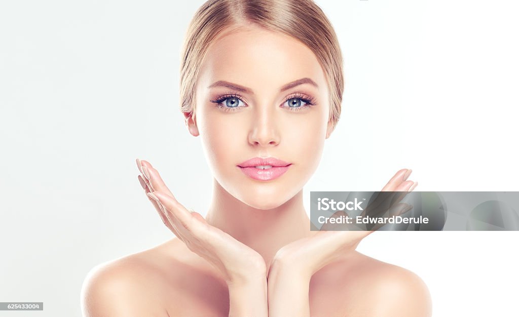 Young Woman with clean, fresh skin.  Portrait of beautiful Young Woman with clean, fresh skin. Facial treatment. Cosmetology, beauty and spa.  Human Face Stock Photo