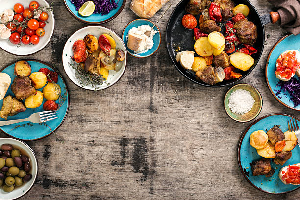istock Dinner table with variety food, top view 625433332