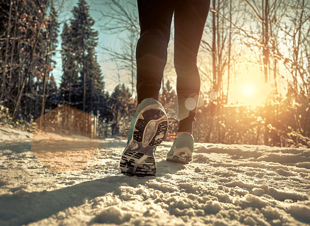 istock Woman Running at snowly winter under sunlight. 625433684