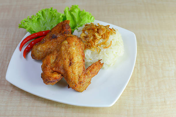 istock fried chicken with sticky rice on wooden background. 625434160