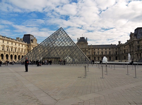 Paris, France - November 5, 2010: the Pyramid of steel and glass, designed by Chinese-born American architect Ieoh Ming Pei, who since 1988 is the main entrance to the Louvre museum