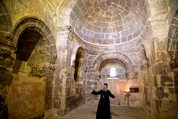 Deyrulzafaran orthodox Syriac monastery in Mardin. Mardin, Turkey- March 28, 2015 : Priest prays in Deyrulzafaran orthodox Syriac monastery in Mardin. midyat photos stock pictures, royalty-free photos & images