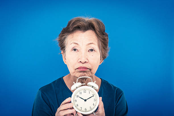 istock elderly woman blue background 625437620