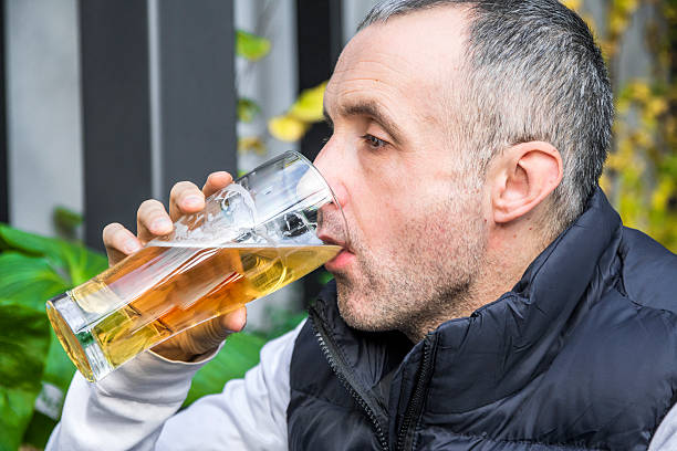 istock Man drinking beer. Side view of handsome man drinking beer 625438350