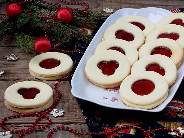 istock Linzer biscuits filled with red jam on wooden background. 625439682