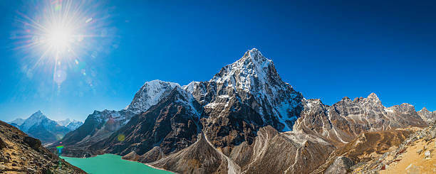 istock Mountain sunburst over dramatic Himalayan peaks panorama Khumbu Nepal 625442112