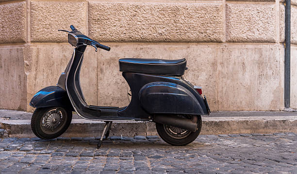 istock Scooter against old wall in Rome 625442604