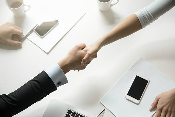 istock Top view of a handshake between man and woman 625444830