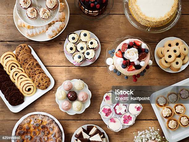 Table With Cakes Cookies Cupcakes Tarts And Cakepops Stock Photo - Download Image Now