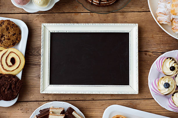 istock Picture frame and cookies, cupcakes and other treats. Copy space 625450954