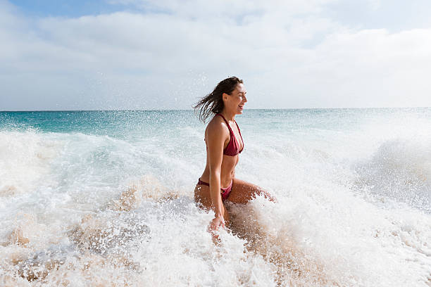 istock young woman having fun at the shoreline, Porthcurno, Cornwall 625451114