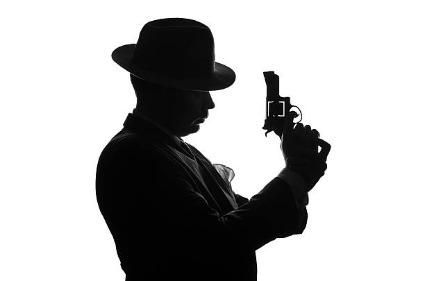 istock Silhouette of private detective with a gun in right hand 625452582