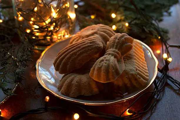 Gingerbread on a plate with fir-branches and Christmas bulbs.
