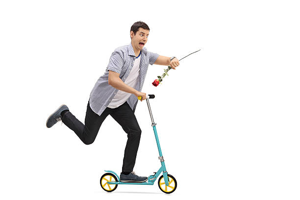 istock Young man riding a scooter and being late 625459010