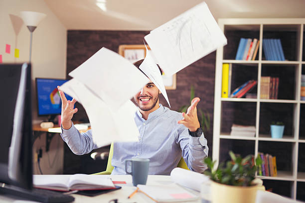 istock Handsome young smiling businessman working with documents in off 625467394