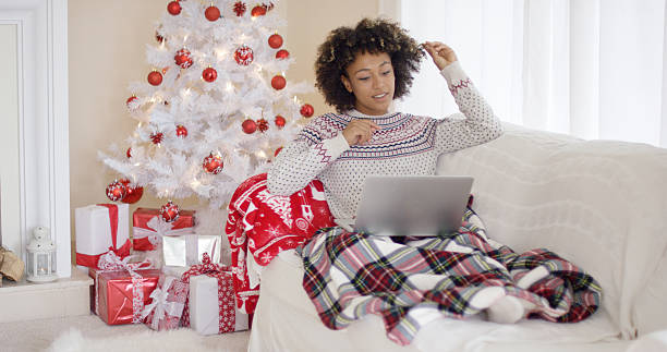 istock Young woman relaxing in front of a Christmas tree 625468366