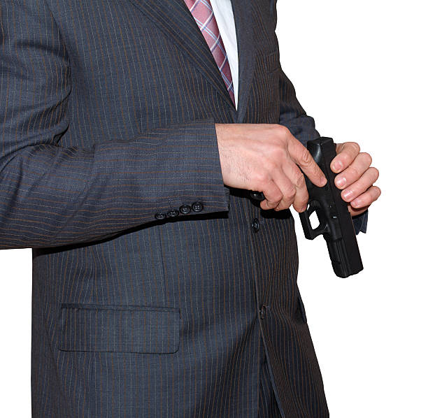 istock Killer with gun in hand close up over white background 625469320